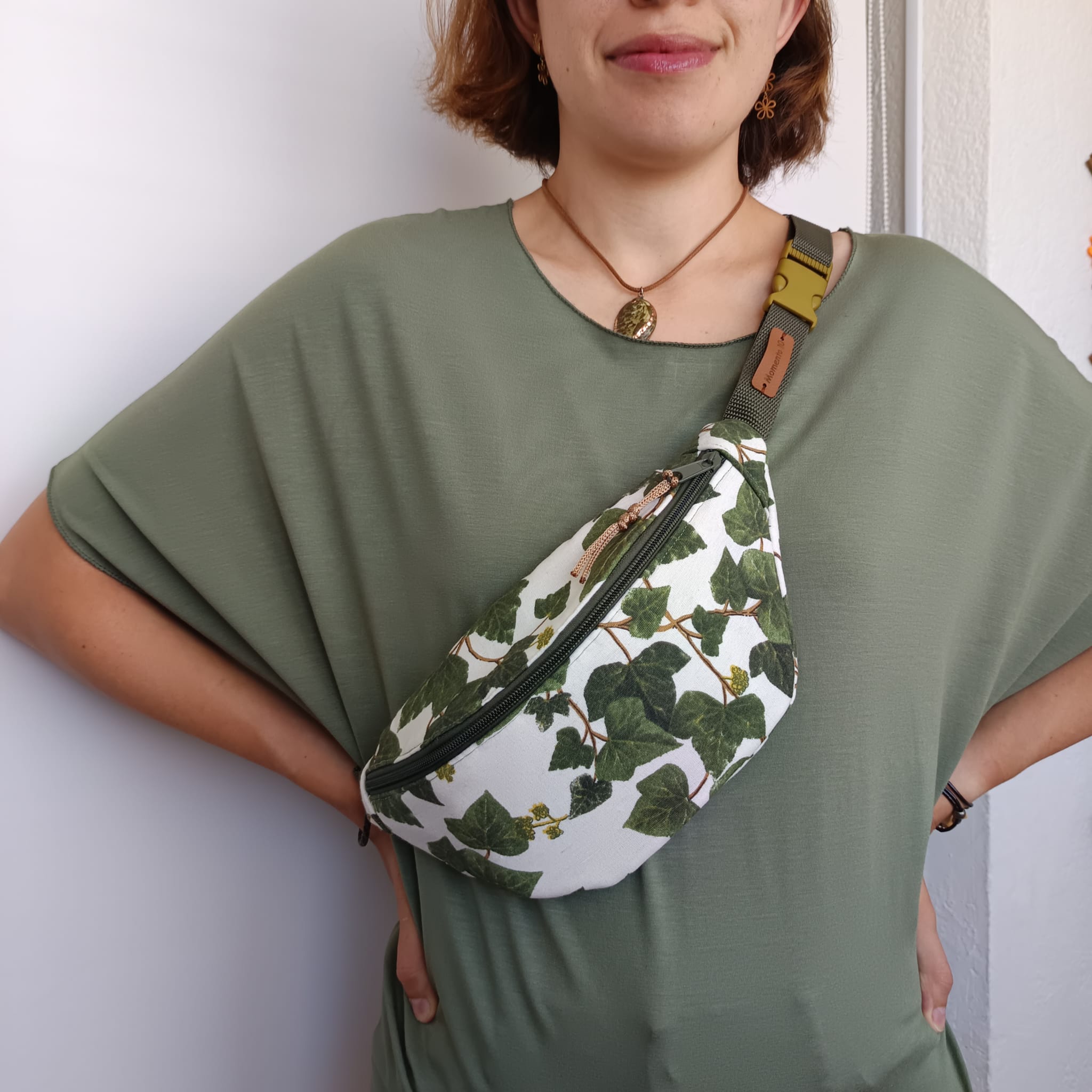 Riñonera de tela verde con estampado de hojas de hiedra